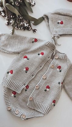 This adorable baby romper set (sold individually) features a crochet mushroom embroidered cardigan and matching hat. Made from soft and organic cotton, it is perfect for newborns up to 3 months old. Ideal for photo shoots, it also makes a unique gift for baby showers and those who love mushrooms and woodland themes. Handmade with love and care. Create a heirloom family traditions with handmade outfit. Add soul to your loved ones newborn photo shootings. I understand that fashion is important but Gender Neutral Crochet Baby Gifts, Crochet Baby Outfits, Mushroom Blanket, Kids Clothes Diy, Dream Nursery, Crochet Baby Gifts, Triplet Babies, Crochet Mushroom, Crochet Baby Clothes