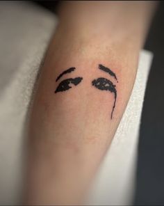 a close up of a person's arm with a face drawn on the side