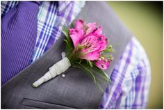 a boutonniere with pink flowers is attached to a man's suit