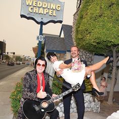 a man holding a woman on his back while posing for a photo in front of a wedding chapel