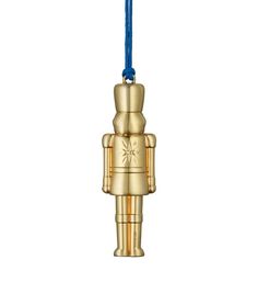 a gold robot ornament hanging from a blue cord