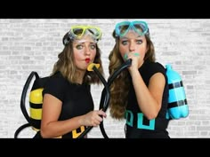 two women wearing scuba goggles and snorkels are posing for the camera