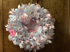 a close up of a wreath on a door with ribbon and scissors attached to it