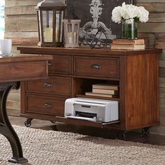 a wooden desk with drawers and a clock on it's wall above the table