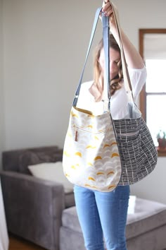 a woman holding onto a purse in her living room