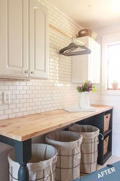 three buckets are sitting on the counter in this white and black laundry room area