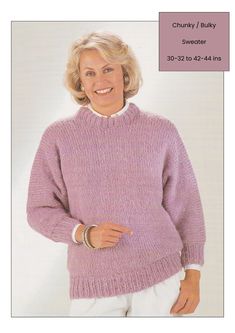 a woman wearing a purple sweater and white pants with her hands on her hips, smiling