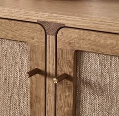 a close up of a wooden cabinet with two handles on the front and back doors