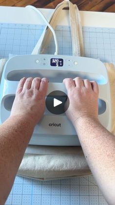 a person is using a machine to cut fabric