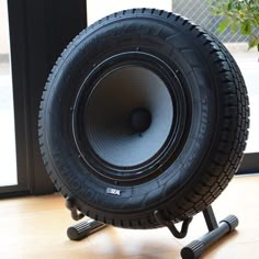 a large tire sitting on top of a wooden floor