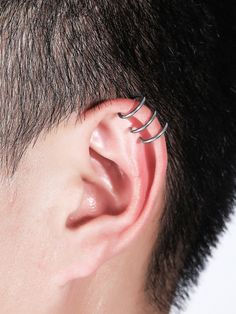 a man with three ear piercings on his ears