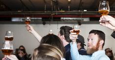 a group of people holding up wine glasses