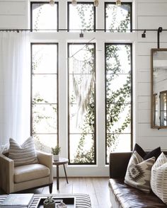 a living room filled with furniture and windows