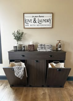 a wooden cabinet with two baskets on top of it in front of a sign that says love and laundry