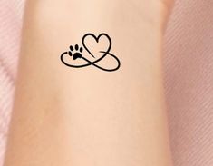 a person with a heart and paw tattoo on their arm