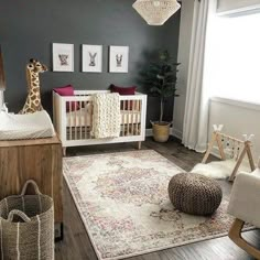 a baby's room with a giraffe rug, crib and other items