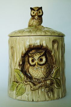 an owl figurine sitting on top of a jar