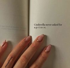 a woman's hand holding an open book with pink nail polish on it and the words cinderella never asked for a prince