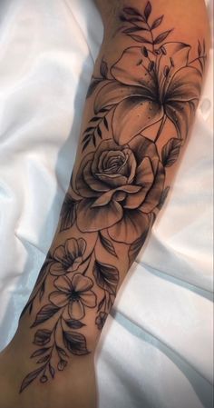 a woman's arm with flowers on it