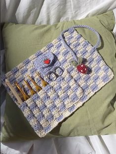 a crocheted bag with scissors and other items