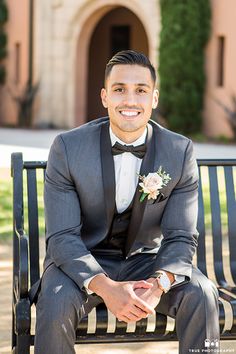 a man in a tuxedo sitting on a bench