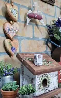 a bird house is on display next to some potted plants