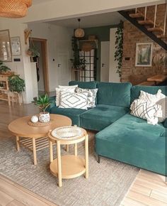 a living room filled with furniture next to a staircase