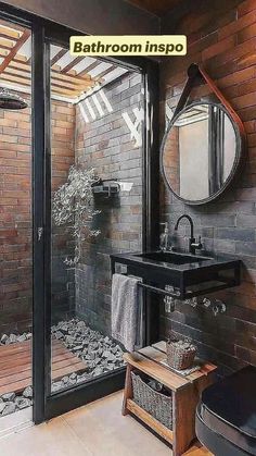 a bathroom with brick walls and a black sink