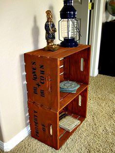 an old wooden crate with writing on it and a small figurine sitting on top