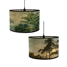 two lamps hanging from the ceiling in front of a white background with trees and foliage