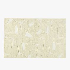 a white rug with an abstract design on it