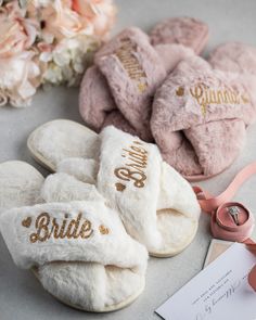 three pairs of slippers with the word bride written on them next to some flowers