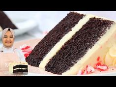 a woman standing next to a large piece of cake