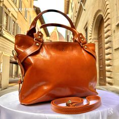 This bag has been made of the best genuine leather by local master crafters of Florence in Italy, designed for women who only accept premium Italian quality and luxury leather bags and modern Italian fashion. . Sizes: Width: 42 cm / 166 inches Height: 25 cm / 9.9 inches Depth: 14 cm / 5.5 inches The story of this bag: Once upon a time in the enchanting city of Florence, a young man named Luca embarked on a special quest. With a desire to find the perfect gift for his beloved mother, he wandered through the winding streets, guided by the whispers of artisans and the aroma of fresh espresso. As he meandered through the bustling marketplaces and elegant boutiques, Luca's eyes were captivated by a display of exquisite handmade leather bags. Each bag exuded a timeless charm, a testament to the Leather Bags For Women, Handmade Leather Bags, Luxury Leather Bag, Soft Leather Bag, Bag Stand, Perfect Gift For Him, Leather Bag Women, Leather Bags Handmade, One Bag