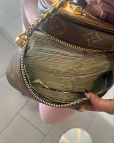 the inside of a louis vuitton purse is being held by someone's hand