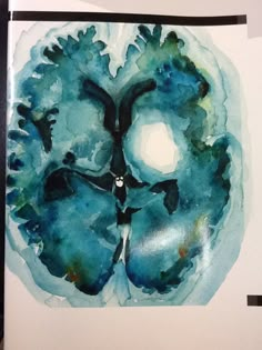 a watercolor painting of a human brain with blue and green colors on the surface