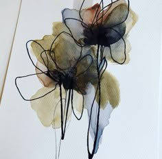 two flowers are shown on a piece of paper with black and white ink in it