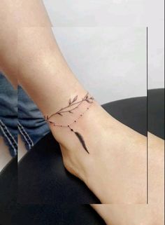 a woman's foot with a small tattoo on the left side of her ankle