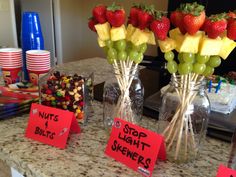 fruit and candy displayed in glass vases on a kitchen counter