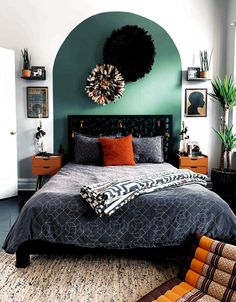 a large bed sitting in a bedroom next to a green wall