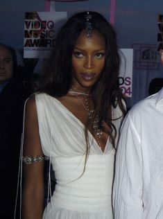 a man and woman standing next to each other in front of a sign that says video music awards