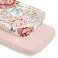 a pink and white floral print baby crib bedding set