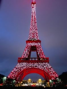 the eiffel tower is lit up in red and white