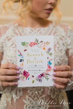 a woman in a wedding dress holding up a card that says hannah patrick on it