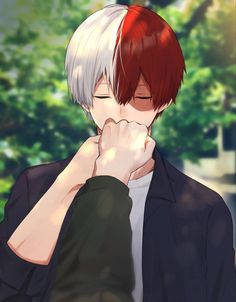 a man with white hair and red eyes is holding his hand to his face