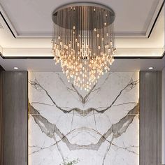 an elegant bathroom with marble walls and chandelier