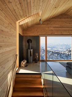 the inside of a house with wooden walls and stairs