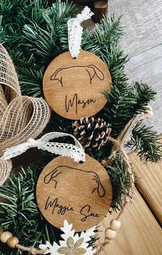 two wooden christmas ornaments on top of a tree