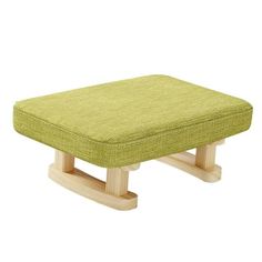 a small wooden foot stool with a green cushion on the top and bottom, sitting in front of a white background