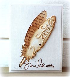 a card with a wooden feather on it